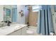 A full bathroom with a tub, shower, and a white marble topped vanity sink at 20114 Uffizi Ct, Venice, FL 34293
