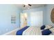 Bright bedroom features light blue walls, white trim, a ceiling fan, and closet storage space at 20114 Uffizi Ct, Venice, FL 34293