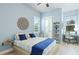 Airy bedroom featuring a ceiling fan, light wood floors, and a modern workstation by the bright windows at 20114 Uffizi Ct, Venice, FL 34293