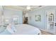 Light and airy bedroom with tray ceilings, a comfortable bed, and light colored walls at 20114 Uffizi Ct, Venice, FL 34293