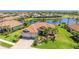 Beautiful single-Gathering home boasts lush landscaping, tile roof, and picturesque water view at 20114 Uffizi Ct, Venice, FL 34293