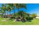 Rear home exterior with lush landscaping and a screened-in lanai, perfect for outdoor living at 20114 Uffizi Ct, Venice, FL 34293