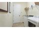 Laundry room with washer, dryer, sink and utility shelving at 20114 Uffizi Ct, Venice, FL 34293