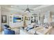 Beautiful open concept living room with custom built-ins and tile flooring at 20114 Uffizi Ct, Venice, FL 34293
