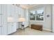 Bright office space with white cabinets, a built-in desk, and a window that provides ample natural light at 20114 Uffizi Ct, Venice, FL 34293