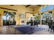 Outdoor patio area with a ping pong table, fireplace, and comfortable seating for relaxing and entertaining at 20114 Uffizi Ct, Venice, FL 34293