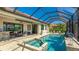 Wonderful home featuring an outdoor oasis with a screened-in lanai, pool, spa, bar, and beautiful landscaping at 20114 Uffizi Ct, Venice, FL 34293