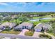 Expansive aerial view of the home, showcasing its proximity to the golf course and lake at 2020 Calusa Lakes Blvd, Nokomis, FL 34275