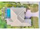 Aerial view of the house and its pool, providing a bird's eye view of its roof and surrounding property at 2020 Calusa Lakes Blvd, Nokomis, FL 34275