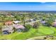 A scenic aerial view of the residential community, featuring a golf course, lakes, and lush greenery at 2020 Calusa Lakes Blvd, Nokomis, FL 34275