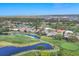 Wide aerial shot of the residential area with multiple lakes, a golf course, and trees and lush greenery at 2020 Calusa Lakes Blvd, Nokomis, FL 34275