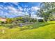 Large backyard featuring a screened pool and mature landscaping that provides privacy and an inviting outdoor space at 2020 Calusa Lakes Blvd, Nokomis, FL 34275