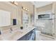 Well-lit bathroom featuring double sinks, a glass shower, and a mosaic tile accent at 2020 Calusa Lakes Blvd, Nokomis, FL 34275