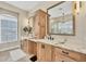 Bathroom featuring custom wood cabinets, double sinks, granite countertops, and a glass enclosed shower at 2020 Calusa Lakes Blvd, Nokomis, FL 34275