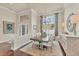 Bright dining room with hardwood floors, large windows, and a statement chandelier at 2020 Calusa Lakes Blvd, Nokomis, FL 34275