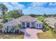 Stunning single-story home with a tile roof, brick driveway, and beautiful landscaping at 2020 Calusa Lakes Blvd, Nokomis, FL 34275