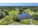 Scenic aerial view of golf course with water features, sand traps, and lush green fairways and putting greens at 2020 Calusa Lakes Blvd, Nokomis, FL 34275
