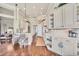 Spacious kitchen with white cabinets, stainless steel appliances, and hardwood floors at 2020 Calusa Lakes Blvd, Nokomis, FL 34275