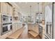Modern kitchen featuring white cabinets, stainless steel appliances, and hardwood flooring at 2020 Calusa Lakes Blvd, Nokomis, FL 34275
