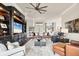 Elegant living room with a dark wood entertainment center and ample seating arrangement at 2020 Calusa Lakes Blvd, Nokomis, FL 34275