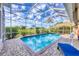 Enclosed pool area with serene water, blue skies, and privacy landscaping at 2020 Calusa Lakes Blvd, Nokomis, FL 34275