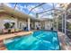 The screened-in pool offers a dining and seating area, creating an outdoor entertainment space at 2020 Calusa Lakes Blvd, Nokomis, FL 34275