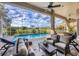 Enclosed pool area featuring outdoor seating and lush landscaping at 2020 Calusa Lakes Blvd, Nokomis, FL 34275