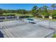 Community tennis courts with new fencing and covered seating areas offer residents the perfect setting for recreation at 2020 Calusa Lakes Blvd, Nokomis, FL 34275