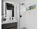 Stylish bathroom with sleek black fixtures, a modern vanity, and a glass-enclosed shower at 2159 Hawthorne St, Sarasota, FL 34239