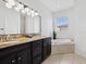 Relaxing bathroom with dual vanities, granite countertops, and a luxurious soaking tub at 2159 Hawthorne St, Sarasota, FL 34239