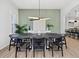 Elegant dining room with modern lighting, plank floors, and light green accent wall at 2159 Hawthorne St, Sarasota, FL 34239