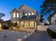 Charming two-story home with a welcoming porch, illuminated landscaping, and a neatly paved driveway at 2159 Hawthorne St, Sarasota, FL 34239