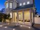 Inviting front porch with classic columns, warm lighting, and meticulously maintained landscaping at 2159 Hawthorne St, Sarasota, FL 34239