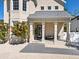 Inviting front porch with a sitting area, columns, and a view of the home's facade at 2159 Hawthorne St, Sarasota, FL 34239