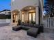 Inviting outdoor living space with a comfortable gray sectional couch and stylish tiled patio, perfect for relaxation at 2159 Hawthorne St, Sarasota, FL 34239