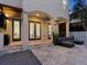 Covered patio area with stone flooring, multiple entrances, and a comfortable outdoor seating area at 2159 Hawthorne St, Sarasota, FL 34239