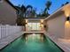 View of the pool area, showing the connecting office space and privacy fence at dusk at 2159 Hawthorne St, Sarasota, FL 34239