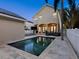 Backyard pool view showing the patio area, rear house elevation, and lush landscaping at 2159 Hawthorne St, Sarasota, FL 34239