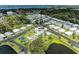 Wonderful aerial view featuring community amenities, including a swimming pool, lake, and clubhouse at 216 Palm Air Dr, Osprey, FL 34229