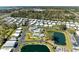 Beautiful aerial view showcasing community amenities, including a swimming pool, lake, and clubhouse at 216 Palm Air Dr, Osprey, FL 34229