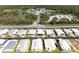 Charming aerial view of a delightful neighborhood surrounded by lush greenery and a serene pond at 216 Palm Air Dr, Osprey, FL 34229
