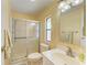 Clean bathroom equipped with walk-in shower, tile floors, and single sink vanity at 216 Palm Air Dr, Osprey, FL 34229