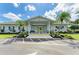 Charming community center entrance framed by tropical landscaping and palm trees at 216 Palm Air Dr, Osprey, FL 34229