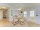 Inviting dining area with a glass table, seating for four, and built in cabinets at 216 Palm Air Dr, Osprey, FL 34229