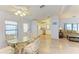 Bright dining area featuring a glass table, four chairs, and wood-look flooring at 216 Palm Air Dr, Osprey, FL 34229