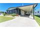 Well-maintained home with a covered carport, a screened-in porch, and manicured landscaping at 216 Palm Air Dr, Osprey, FL 34229