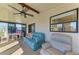 Bright, airy sunroom featuring comfortable seating, ceiling fan, and views of the outdoors at 216 Palm Air Dr, Osprey, FL 34229