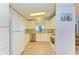 Bright kitchen with white cabinets, stainless steel appliances, and wood-look floors at 216 Palm Air Dr, Osprey, FL 34229
