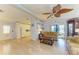 Open living area features tile floors, neutral walls, a ceiling fan and leads into the kitchen at 216 Palm Air Dr, Osprey, FL 34229