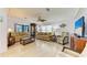 Bright and airy living room featuring neutral furniture, wood-look floors, and ample natural light at 216 Palm Air Dr, Osprey, FL 34229